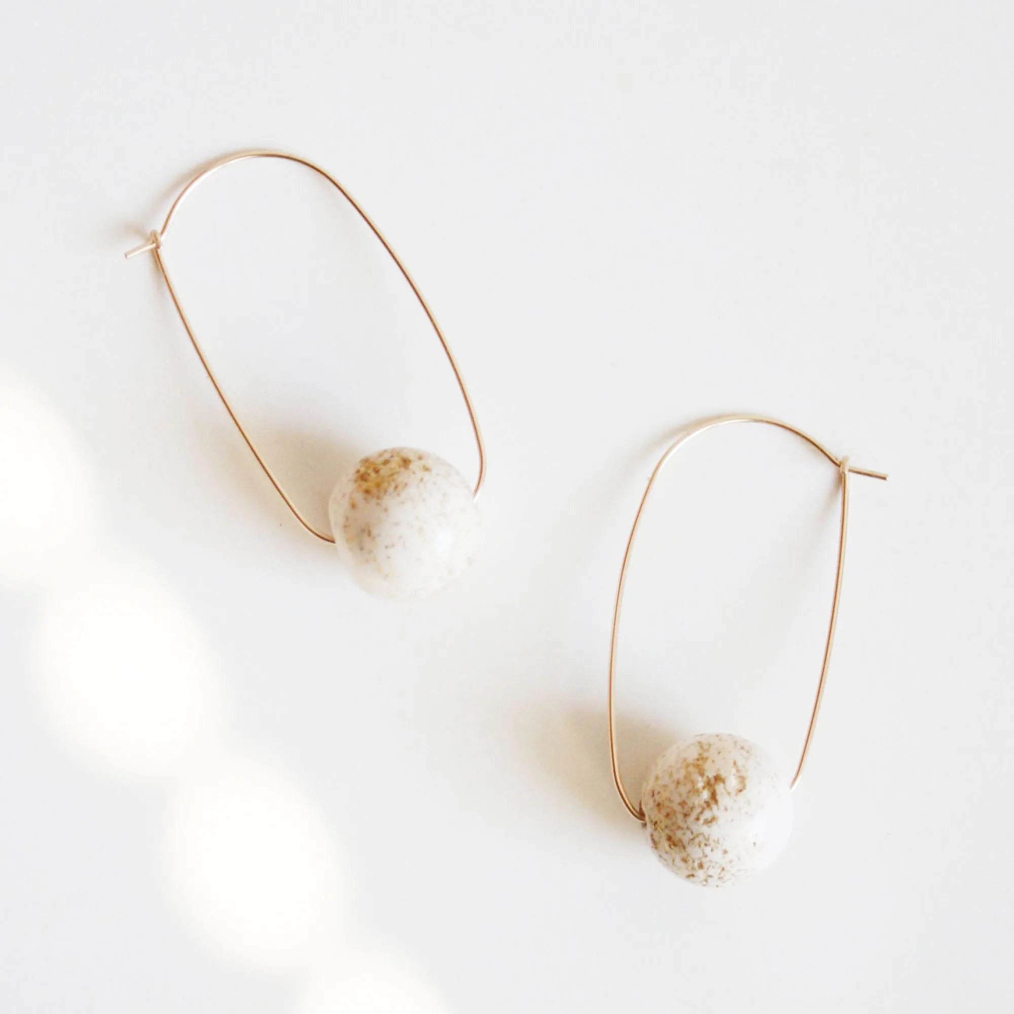 Oval Hoop Earrings with Large White Balls